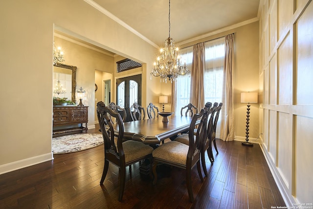 dining space featuring dark wood-type flooring, ornamental molding, french doors, and a chandelier