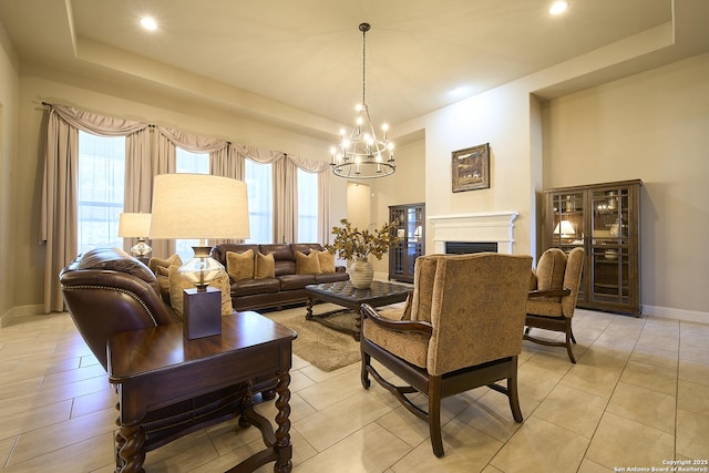 living room featuring light tile patterned floors, a tray ceiling, and a notable chandelier