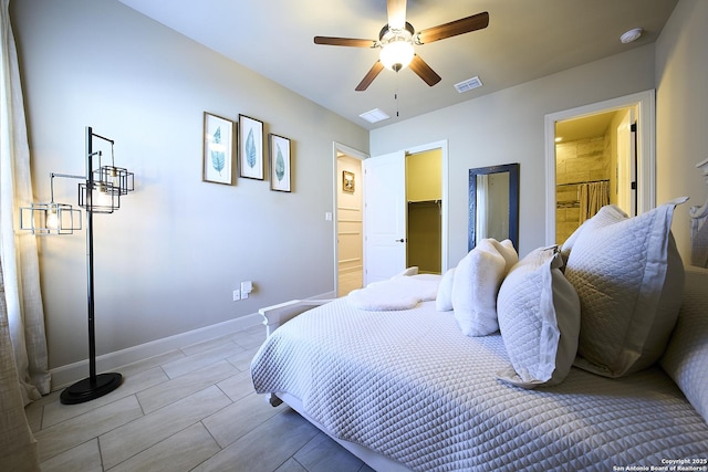 bedroom with ceiling fan, a walk in closet, and a closet