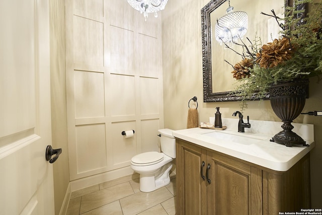 bathroom featuring tile patterned floors, vanity, and toilet