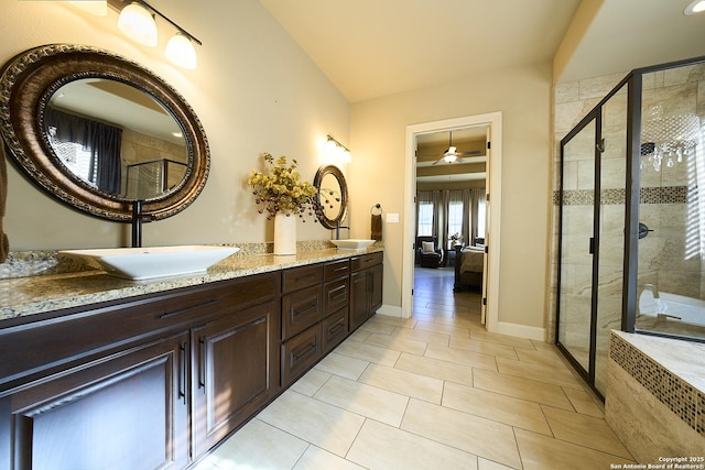 bathroom featuring tile patterned flooring, vanity, and a shower with door