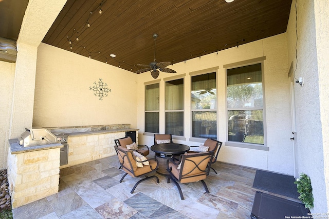 view of patio with ceiling fan and an outdoor kitchen