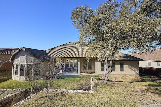 rear view of house featuring a patio and a lawn