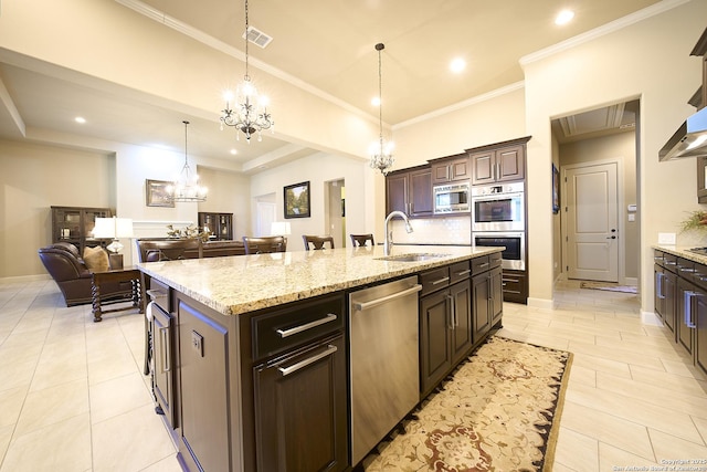 kitchen with sink, a kitchen island with sink, dark brown cabinets, stainless steel appliances, and a chandelier