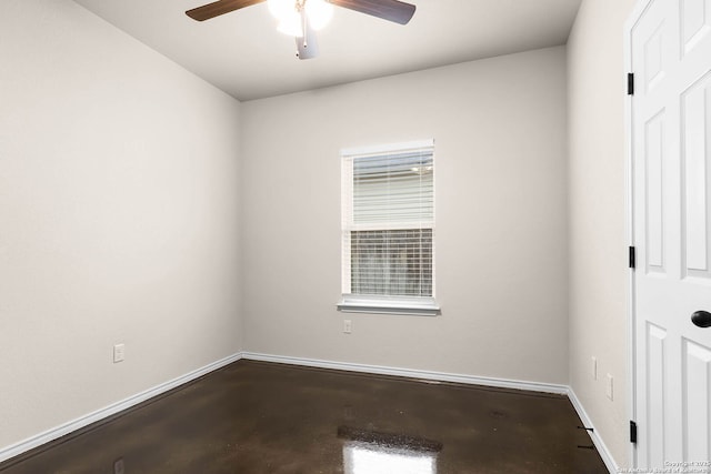 empty room with concrete flooring and ceiling fan