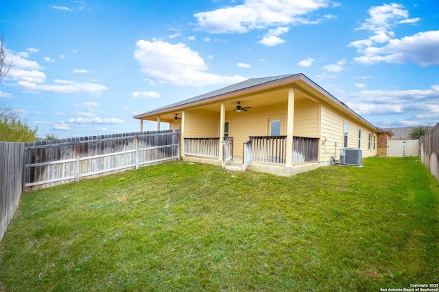 back of house featuring central AC, a lawn, and ceiling fan