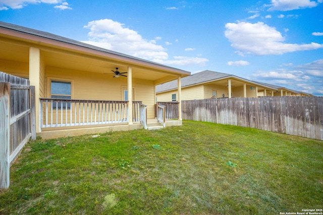 view of yard with ceiling fan