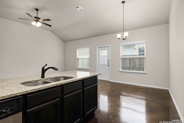 kitchen with pendant lighting, sink, light stone counters, vaulted ceiling, and stainless steel dishwasher