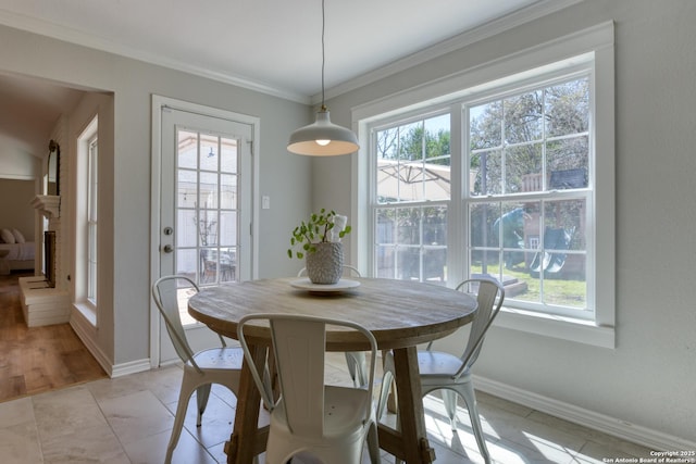 dining room featuring ornamental molding and baseboards