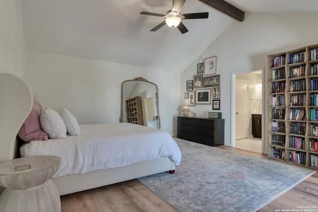 bedroom featuring ensuite bath, high vaulted ceiling, beamed ceiling, and wood finished floors