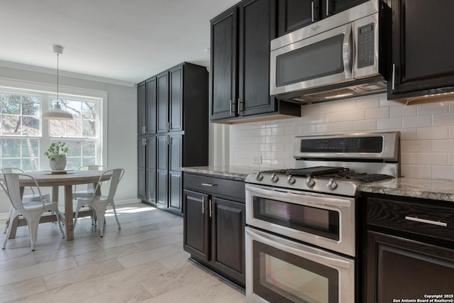 kitchen featuring backsplash, light stone counters, stainless steel appliances, and crown molding