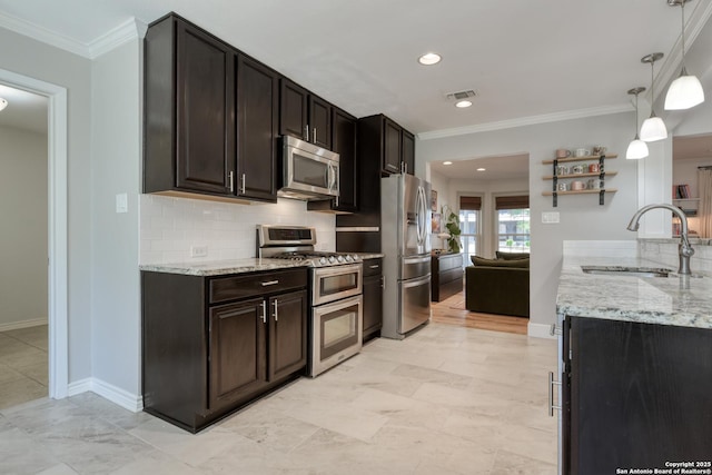 kitchen featuring stainless steel appliances, visible vents, decorative backsplash, ornamental molding, and a sink