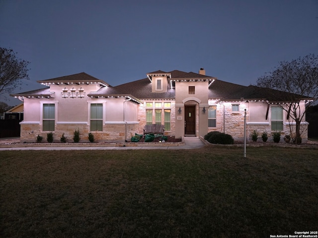 mediterranean / spanish house featuring a yard