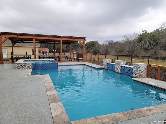 view of swimming pool with an in ground hot tub and a patio area