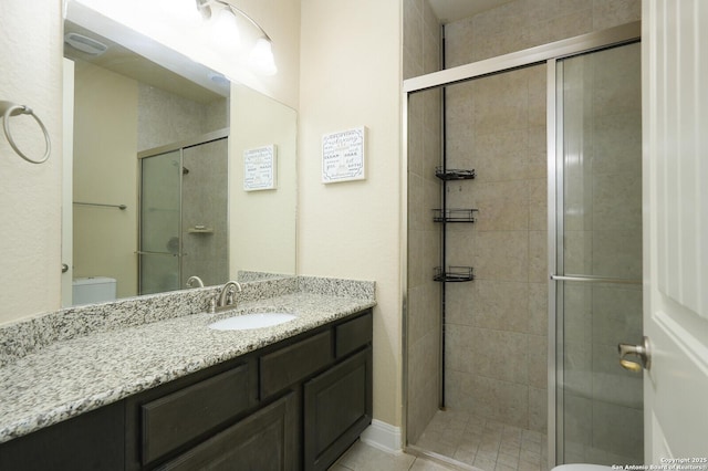 bathroom featuring vanity, a shower with door, and toilet