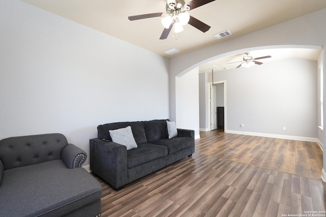 living room featuring ceiling fan and dark hardwood / wood-style flooring