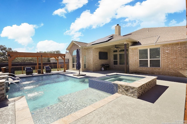 view of pool featuring a pergola, a patio area, pool water feature, and an in ground hot tub