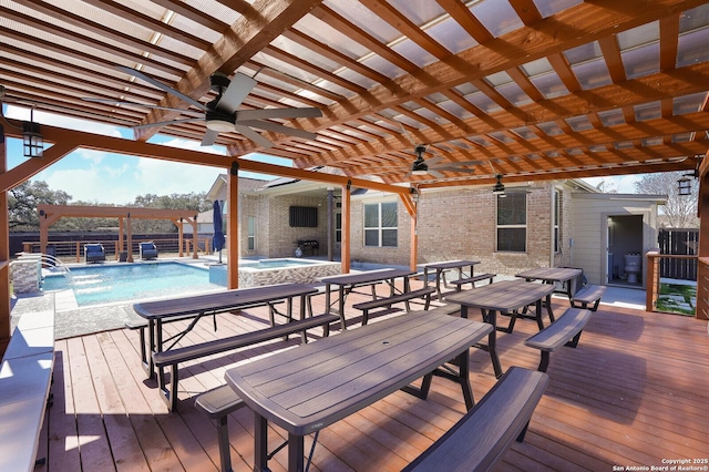 wooden deck with pool water feature, a pergola, and a pool with hot tub