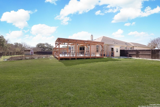 rear view of property with a yard and a deck