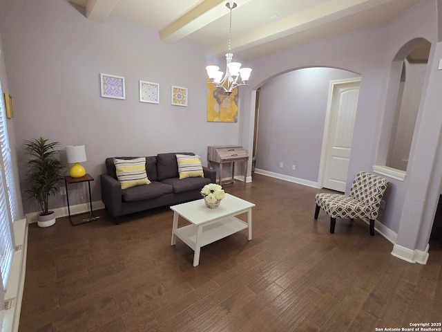 living room featuring dark wood-type flooring, a chandelier, and beamed ceiling