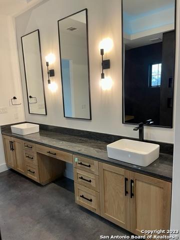 bathroom with vanity and concrete flooring