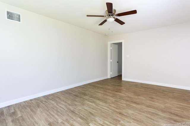 spare room with wood-type flooring and ceiling fan