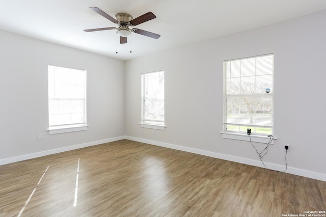 empty room featuring hardwood / wood-style flooring and ceiling fan