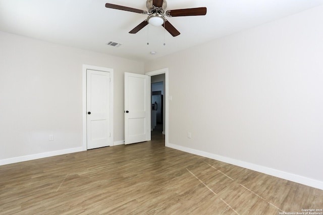 spare room featuring hardwood / wood-style flooring and ceiling fan