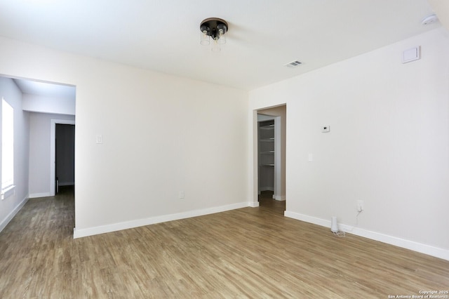 empty room with hardwood / wood-style flooring