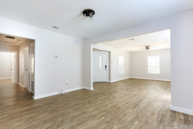 spare room featuring wood-type flooring and ceiling fan