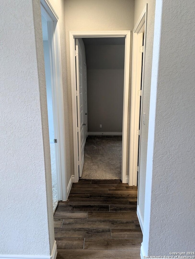 corridor with dark hardwood / wood-style floors