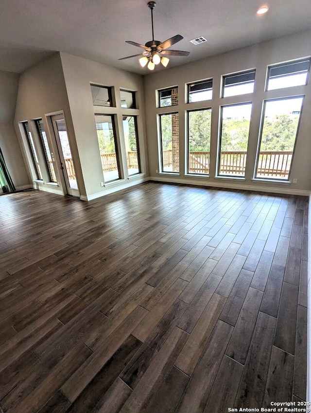 unfurnished living room with dark wood-type flooring and ceiling fan