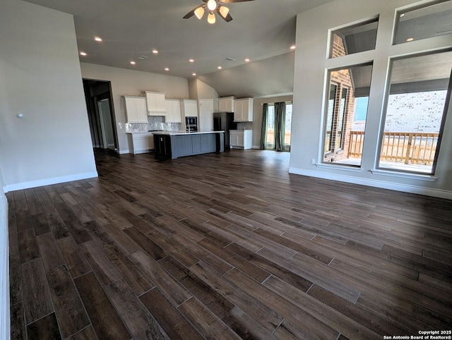 unfurnished living room with ceiling fan and dark hardwood / wood-style flooring