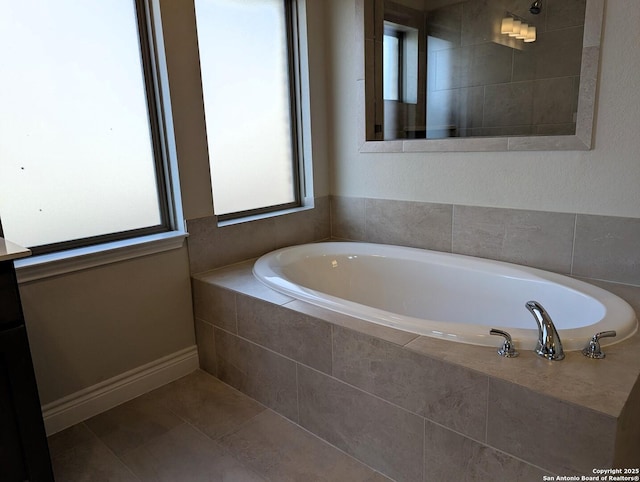 bathroom with tile patterned flooring and tiled bath