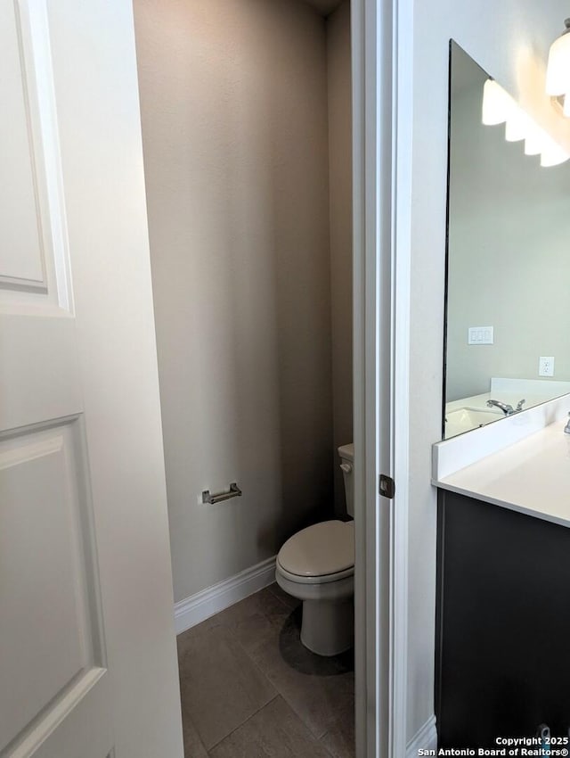 bathroom with vanity, tile patterned floors, and toilet