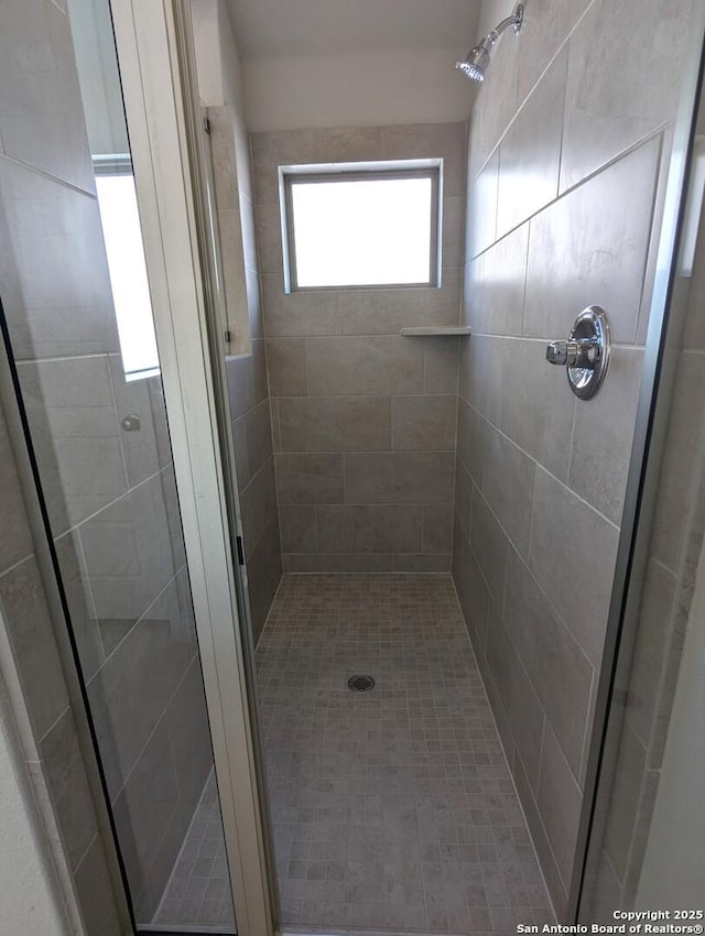 bathroom with tiled shower