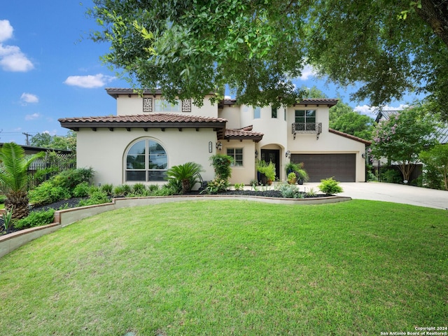 mediterranean / spanish-style house with a garage and a front lawn