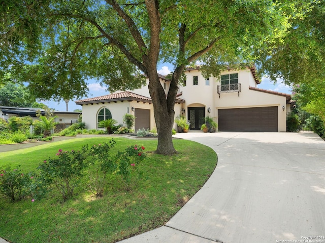 mediterranean / spanish-style house featuring a front lawn