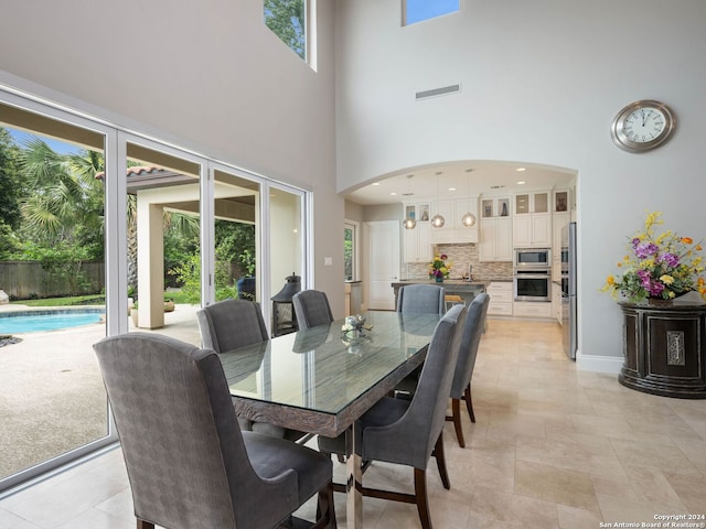 dining room with a towering ceiling