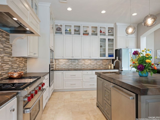 kitchen with appliances with stainless steel finishes, sink, and white cabinets