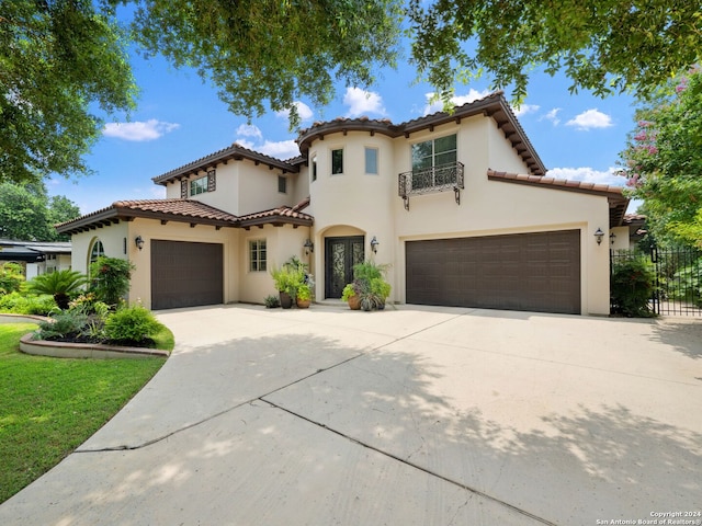 mediterranean / spanish home with a garage