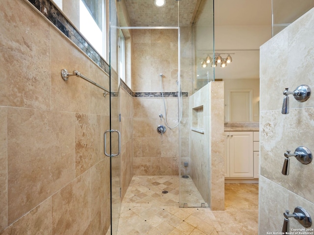 bathroom with vanity and a shower with shower door