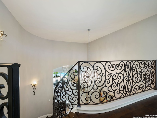 stairs featuring an inviting chandelier and hardwood / wood-style flooring