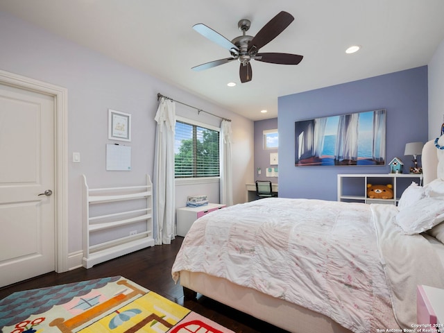 bedroom with dark hardwood / wood-style flooring and ceiling fan