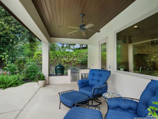 view of patio / terrace featuring ceiling fan and an outdoor kitchen