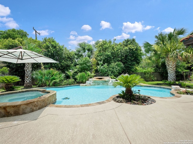 view of swimming pool featuring an in ground hot tub and a patio