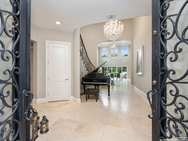 foyer entrance featuring light tile patterned flooring and a chandelier