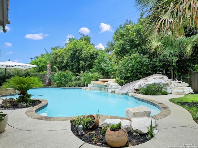 view of pool with a water slide