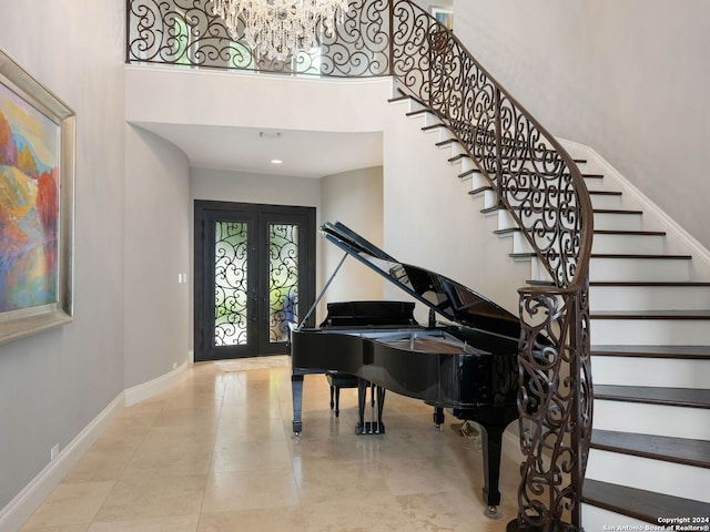 miscellaneous room with a towering ceiling and french doors