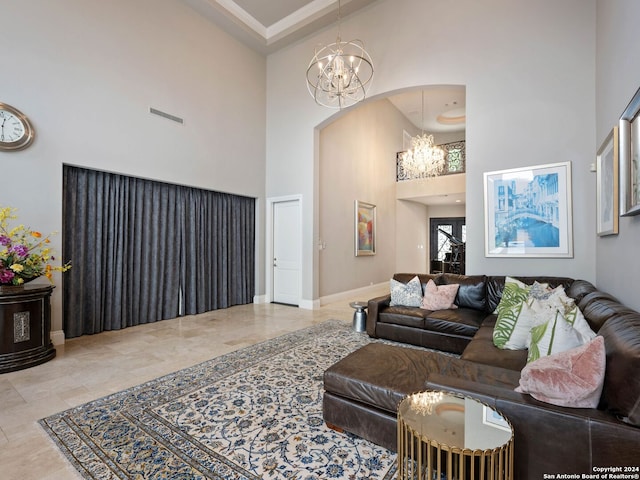 living room with a chandelier and a high ceiling